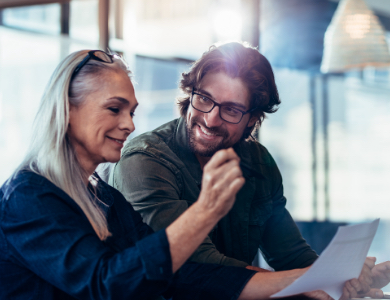 two people in an office reviewing a document