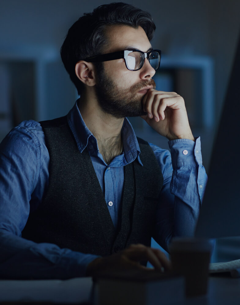 a person concentrating and looking at a computer